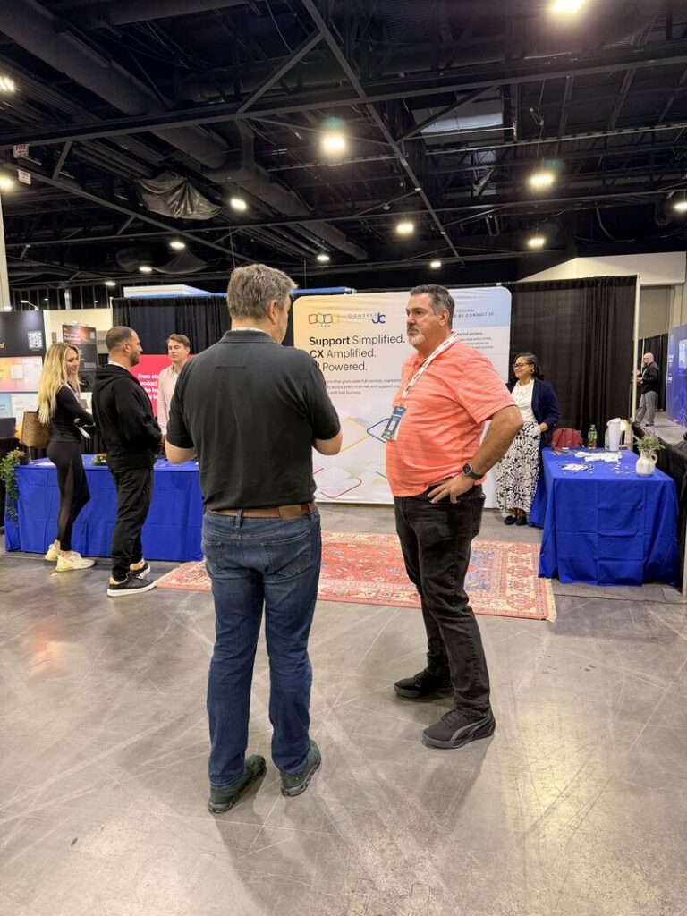 Booth conversation at Customer Connect Expo